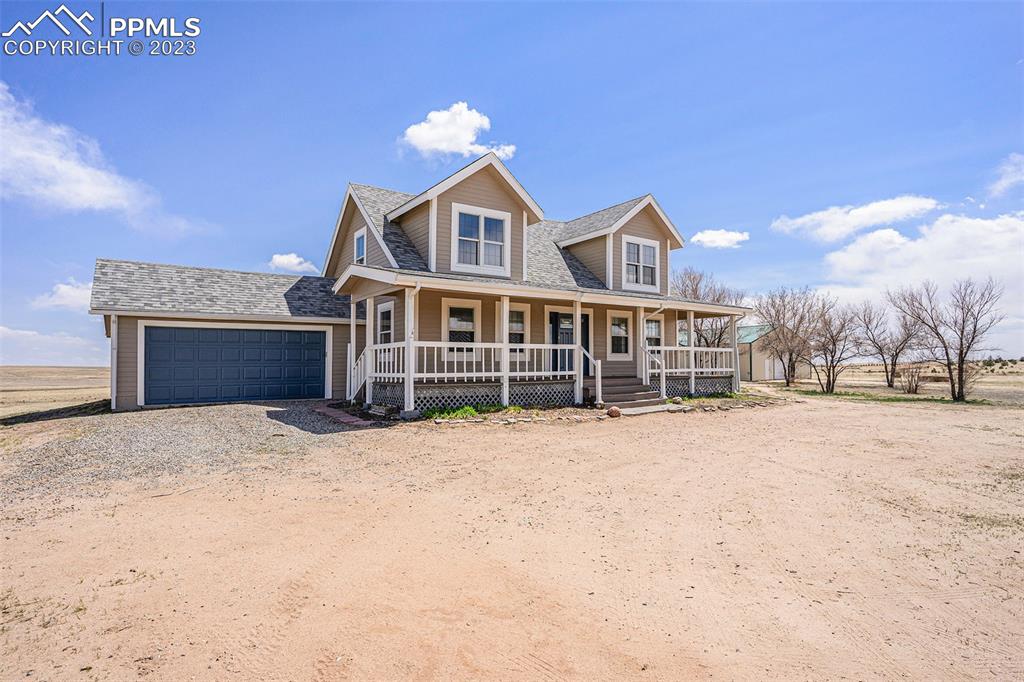 11615 Oil Well Road Calhan, CO 80808 - Photo 2 of 37 a front view of a house with a yard