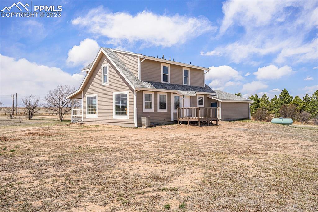 11615 Oil Well Road Calhan, CO 80808 - Photo 26 of 37 a big house with a big yard and large trees