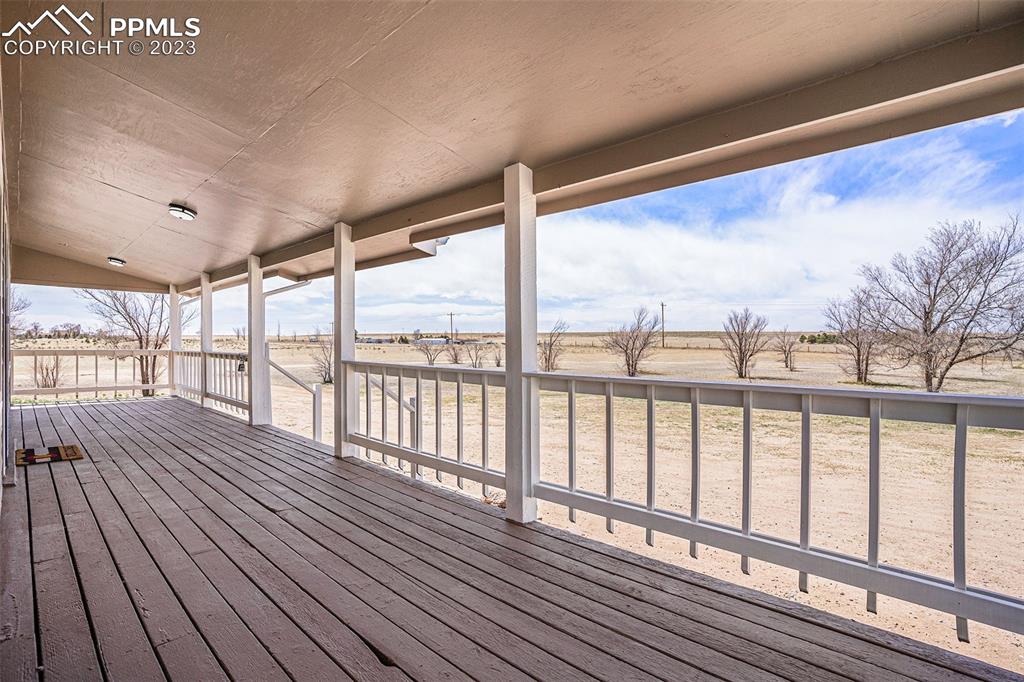 11615 Oil Well Road Calhan, CO 80808 - Photo 4 of 37 a view of balcony with wooden floor