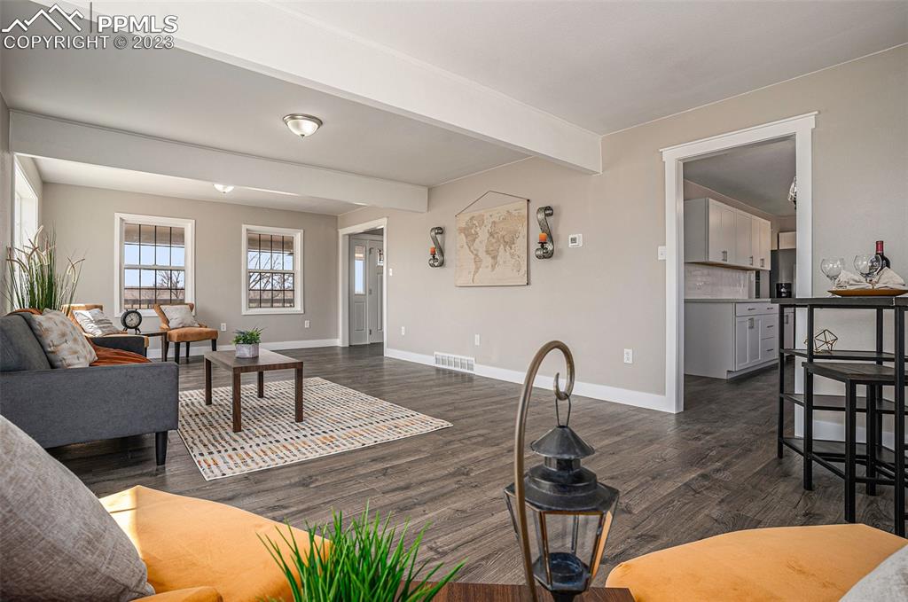 11615 Oil Well Road Calhan, CO 80808 - Photo 8 of 37 a living room with furniture a window and a flat screen tv