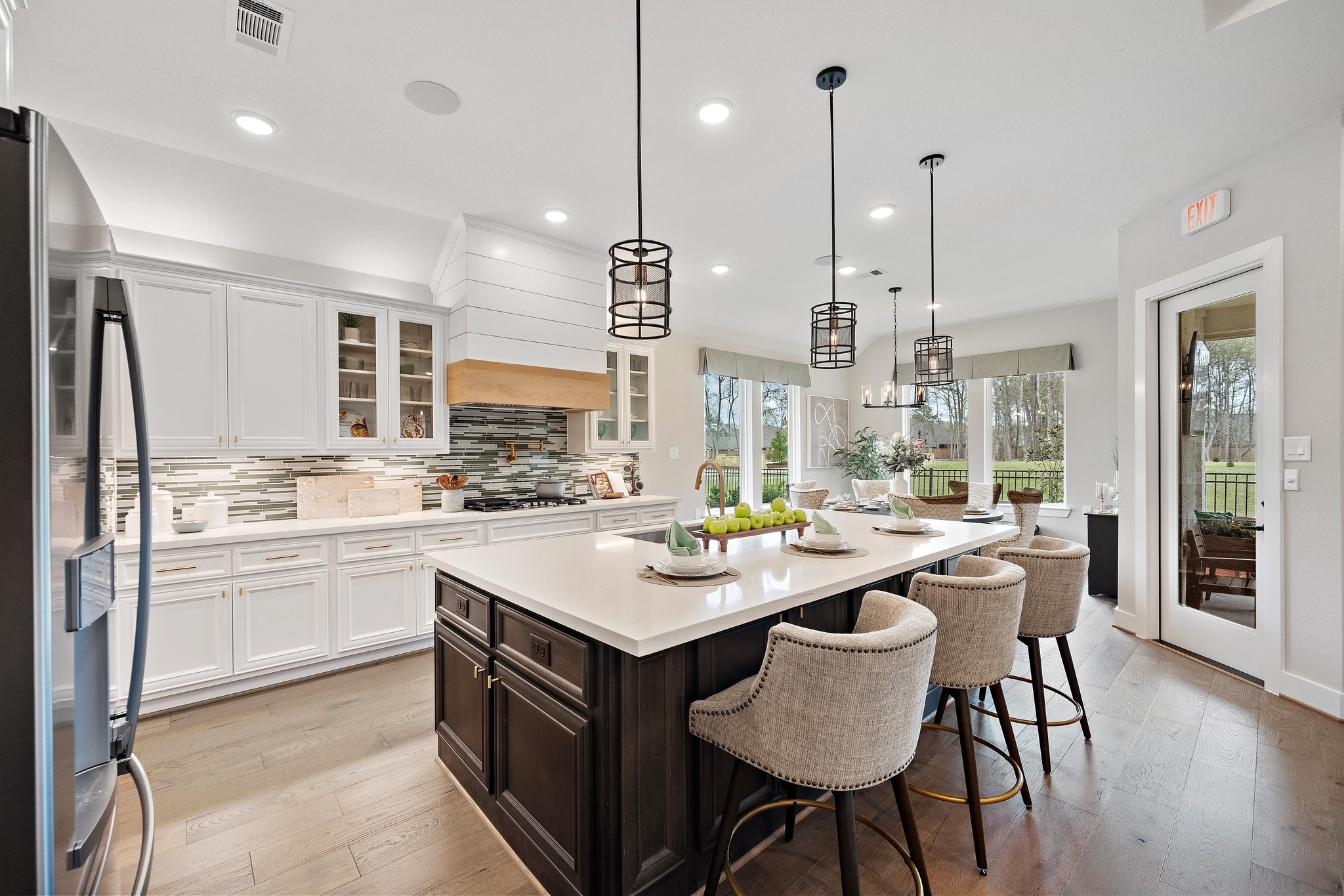 21702 Leaton Circle Porter, TX 77365 - Photo 8 of 36 Gourmet kitchen featuring an oversized island, upgraded cabinetry, designer lighting, and open flow to main living areas—fully furnished for a seamless move-in experience.