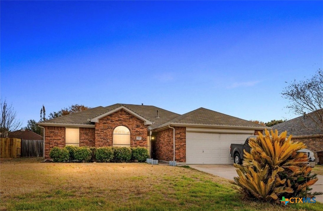 512 South Mockingbird Lane Lockhart, TX 78644 - Photo 1 of 22 a front view of a house with a yard and garage