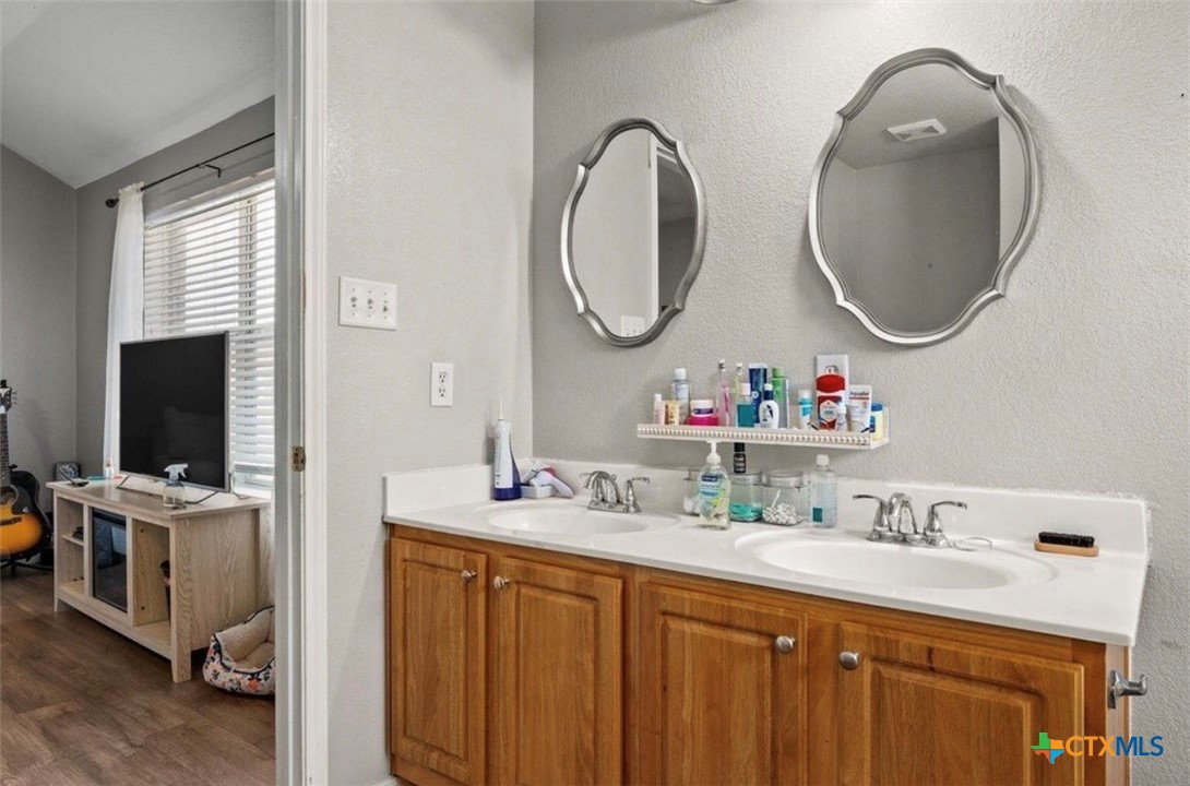 512 South Mockingbird Lane Lockhart, TX 78644 - Photo 15 of 22 a bathroom with a sink and a mirror