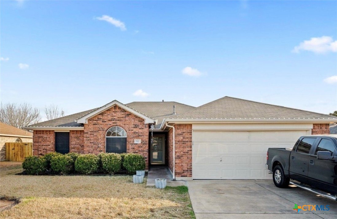 512 South Mockingbird Lane Lockhart, TX 78644 - Photo 2 of 22 a view of a white house next to a yard