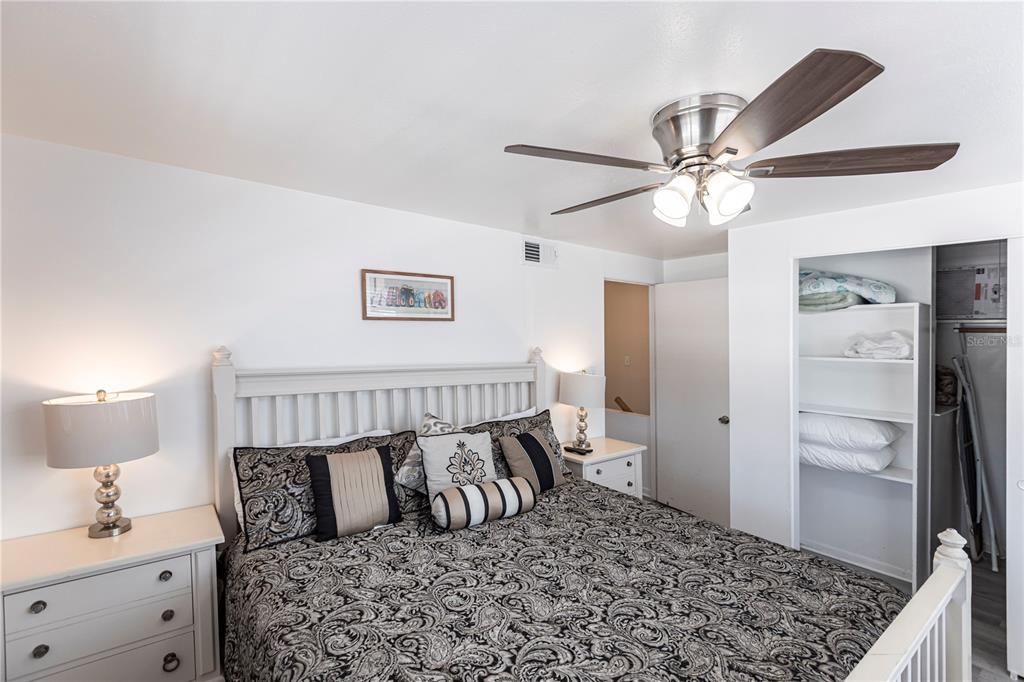 6020 Midnight Pass Road, Unit 50 Sarasota, FL 34242 - Photo 11 of 22 a bedroom with a large bed and a chandelier