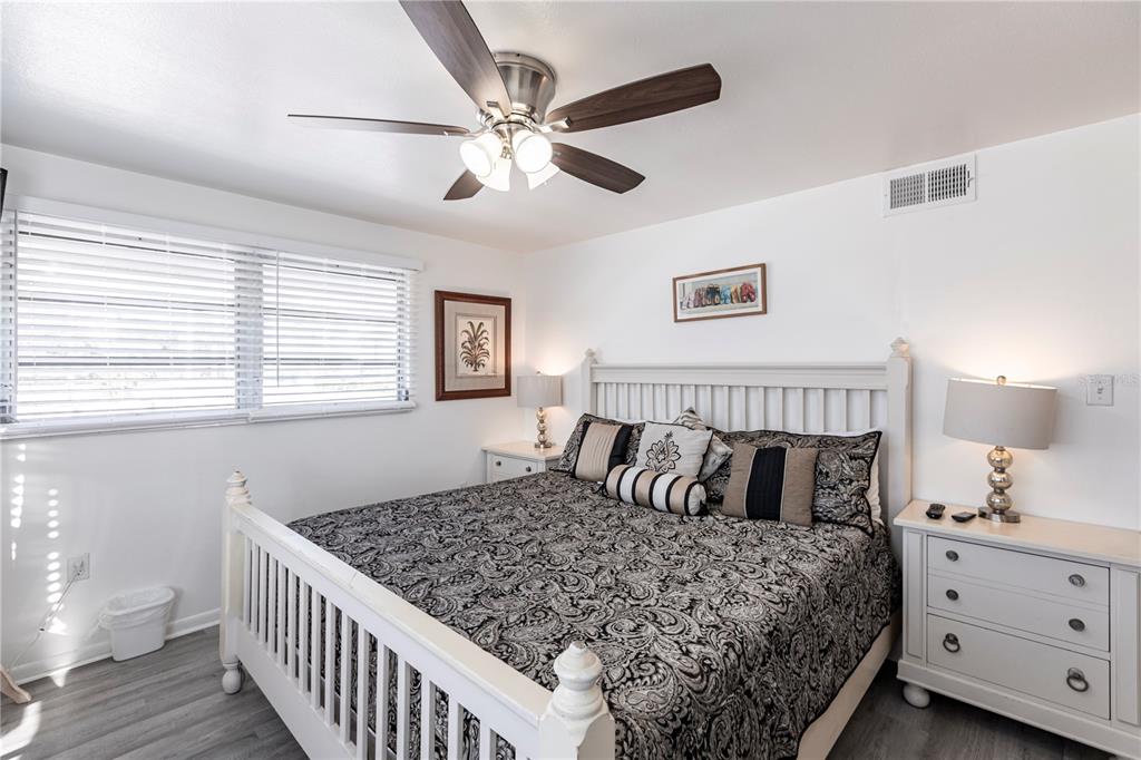 6020 Midnight Pass Road, Unit 50 Sarasota, FL 34242 - Photo 12 of 22 a bedroom with a large bed and a window