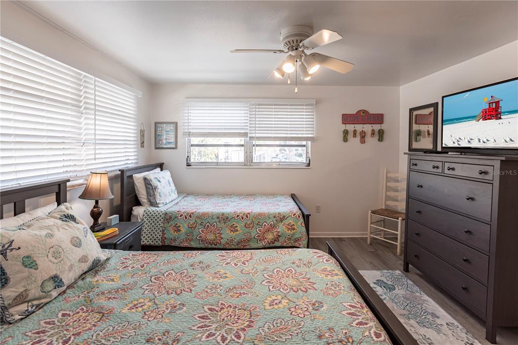 6020 Midnight Pass Road, Unit 50 Sarasota, FL 34242 - Photo 19 of 22 a bedroom with a bed and furniture