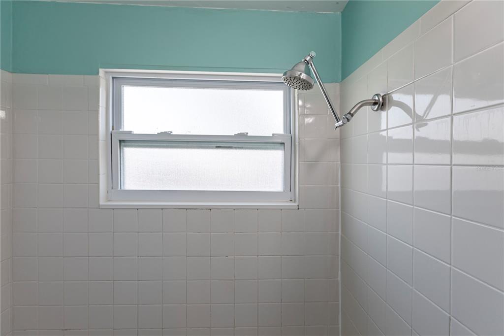 6020 Midnight Pass Road, Unit 50 Sarasota, FL 34242 - Photo 22 of 22 a bathroom with a window and a shower