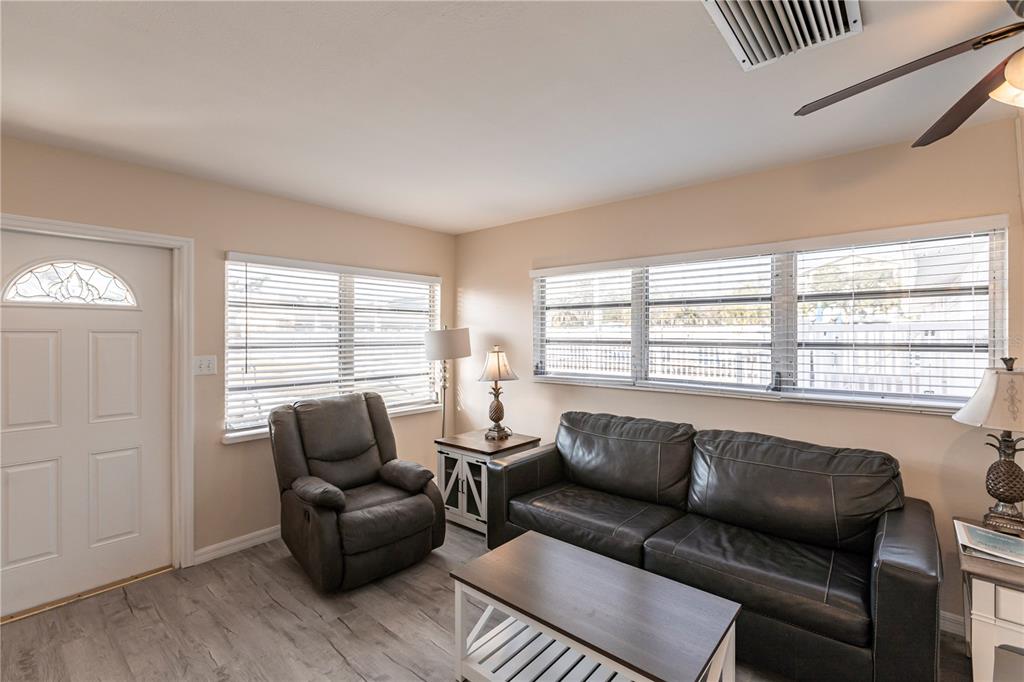 6020 Midnight Pass Road, Unit 50 Sarasota, FL 34242 - Photo 4 of 22 a living room with furniture and a window