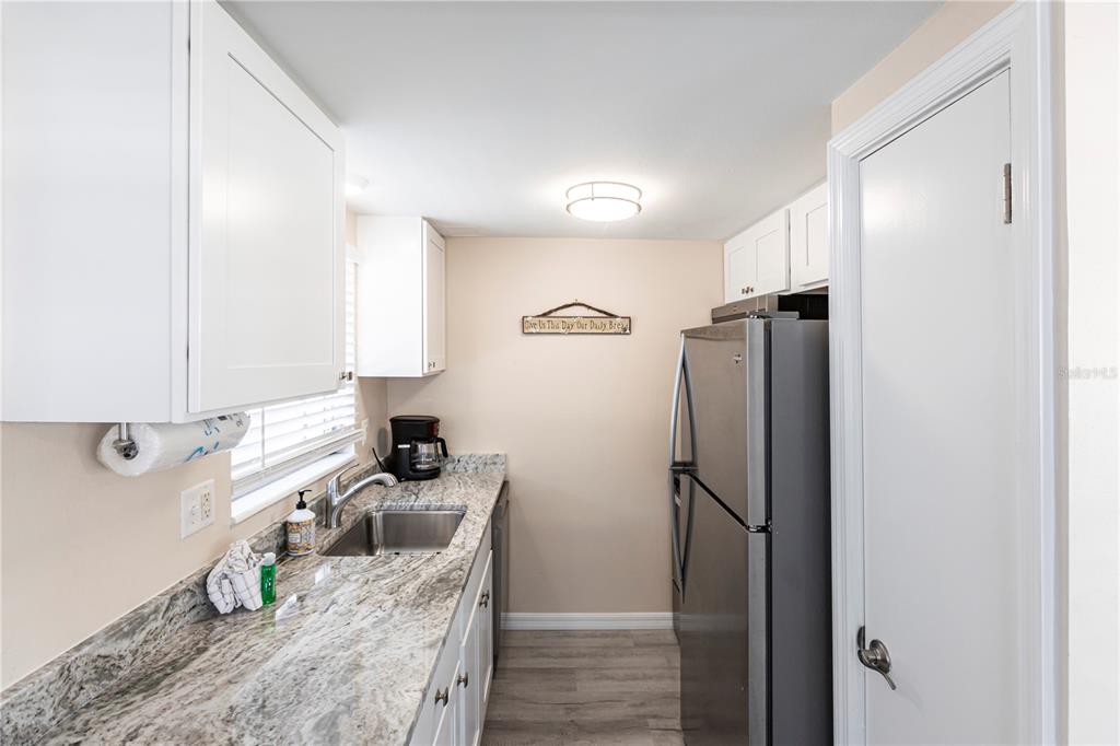 6020 Midnight Pass Road, Unit 50 Sarasota, FL 34242 - Photo 6 of 22 a kitchen with a refrigerator and a sink