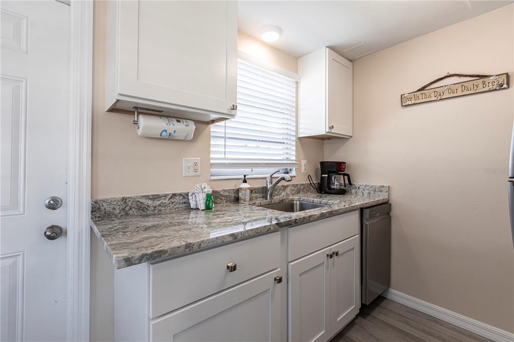 6020 Midnight Pass Road, Unit 50 Sarasota, FL 34242 - Photo 7 of 22 a kitchen with a sink and cabinets