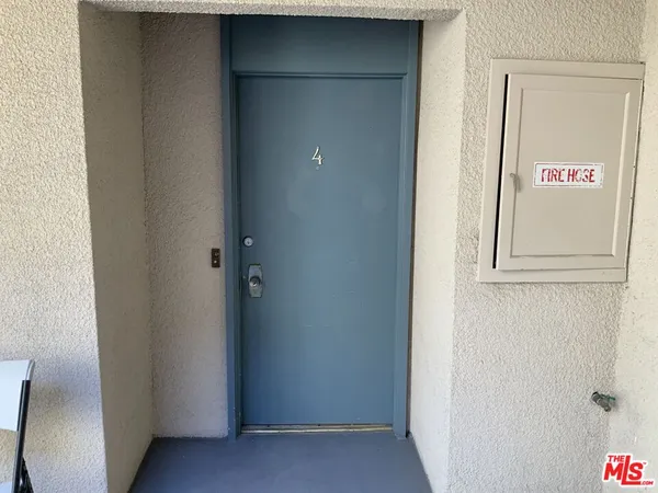 an empty room with floor to ceiling windows and an outdoor view