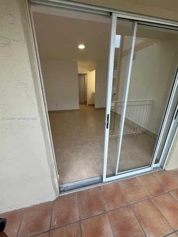 a view of kitchen and hall with wooden floor