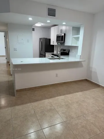 a kitchen with a sink stove and refrigerator