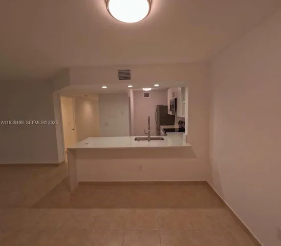 a group of people sitting on a park with palm trees