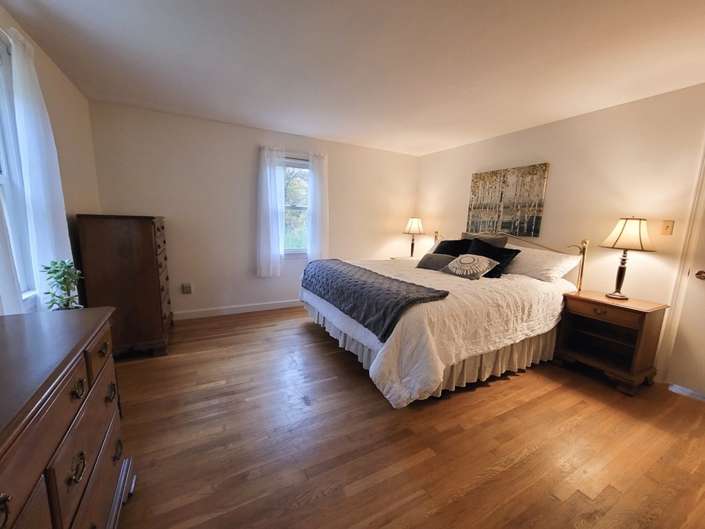 7 Rack Road Chelmsford, MA 01824 - Photo 16 of 29 a bedroom with a bed and a flat tv screen on a dresser