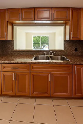 a kitchen with cabinets and window