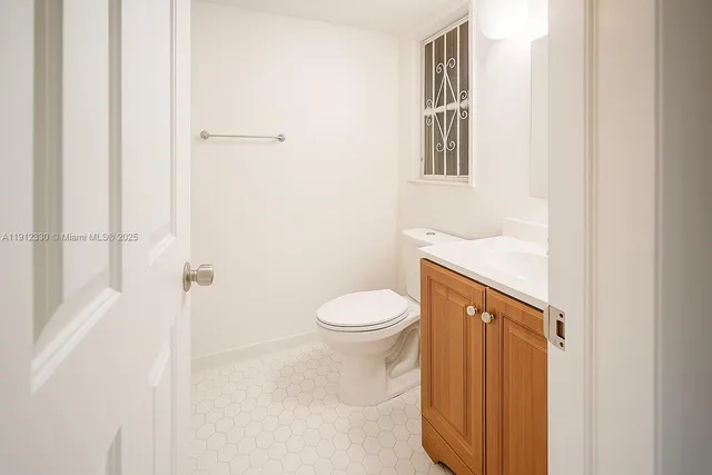 a bathroom with a toilet a sink and a window