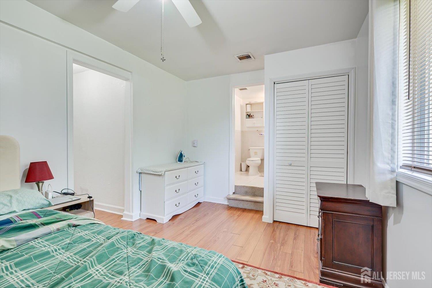 15 Markham Road Edison, NJ 08817 - Photo 20 of 32 a bedroom with a bed and wooden floor