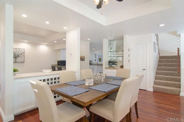 a dining room with furniture and wooden floor