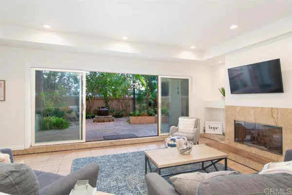a living room with furniture a fireplace and a flat screen tv