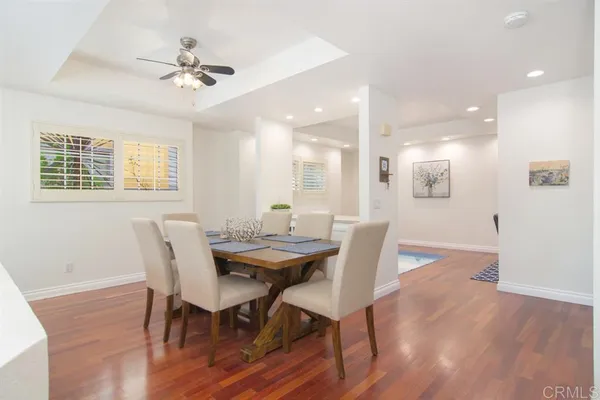 a view of a dining room with furniture and wooden floor