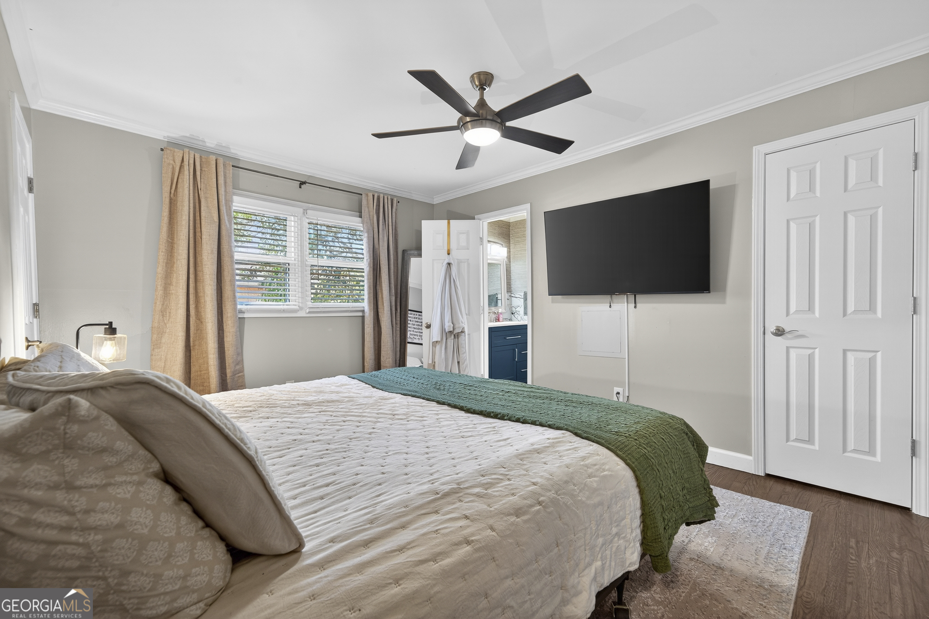 1739 Elmwood Road Milledgeville, GA 31061 - Photo 15 of 41 a bedroom with a bed a flat screen tv and a window