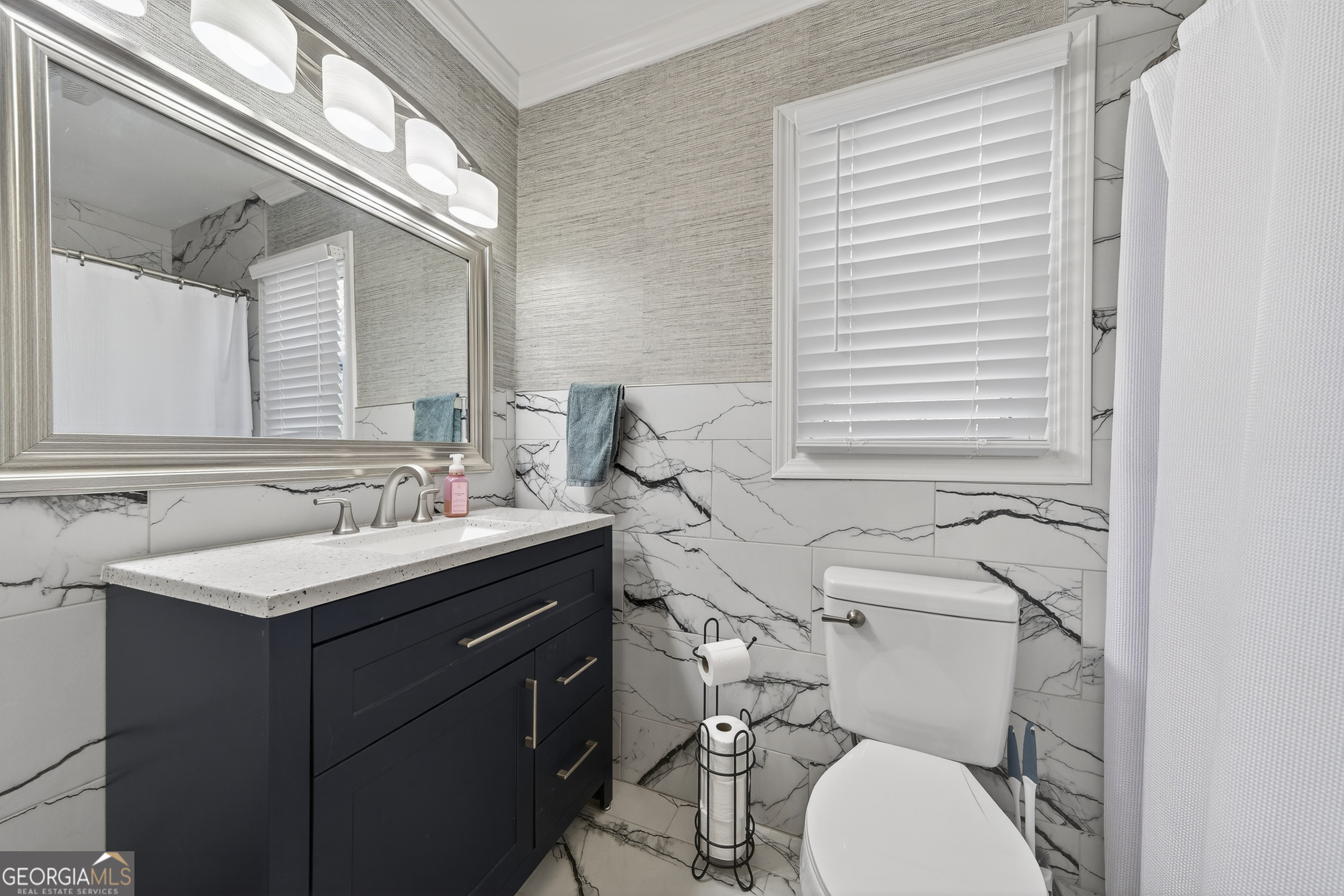 1739 Elmwood Road Milledgeville, GA 31061 - Photo 17 of 41 a bathroom with a granite countertop toilet sink and mirror