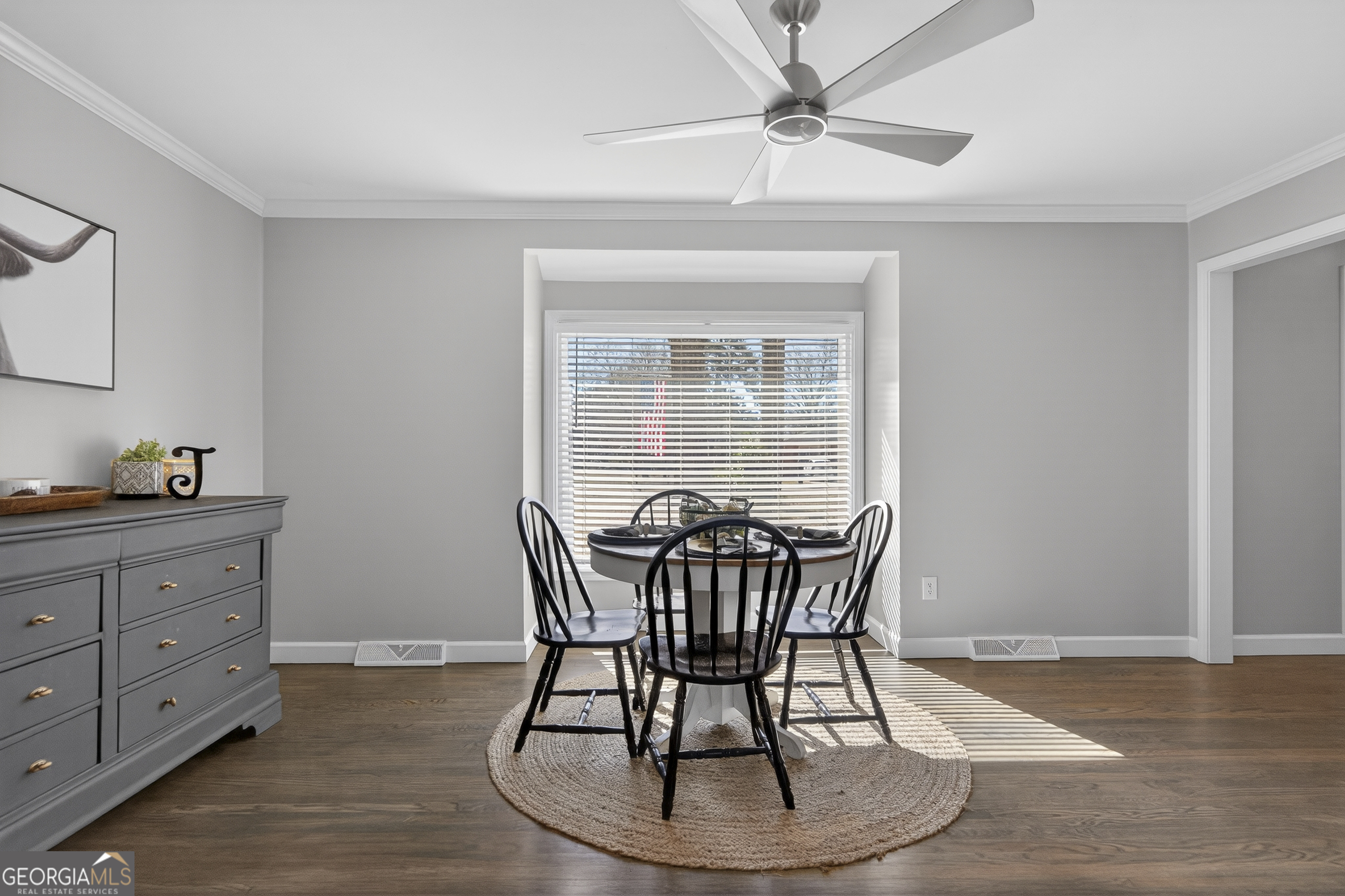 1739 Elmwood Road Milledgeville, GA 31061 - Photo 20 of 41 a dining room with wooden floor a chandelier fan a wooden table and chairs