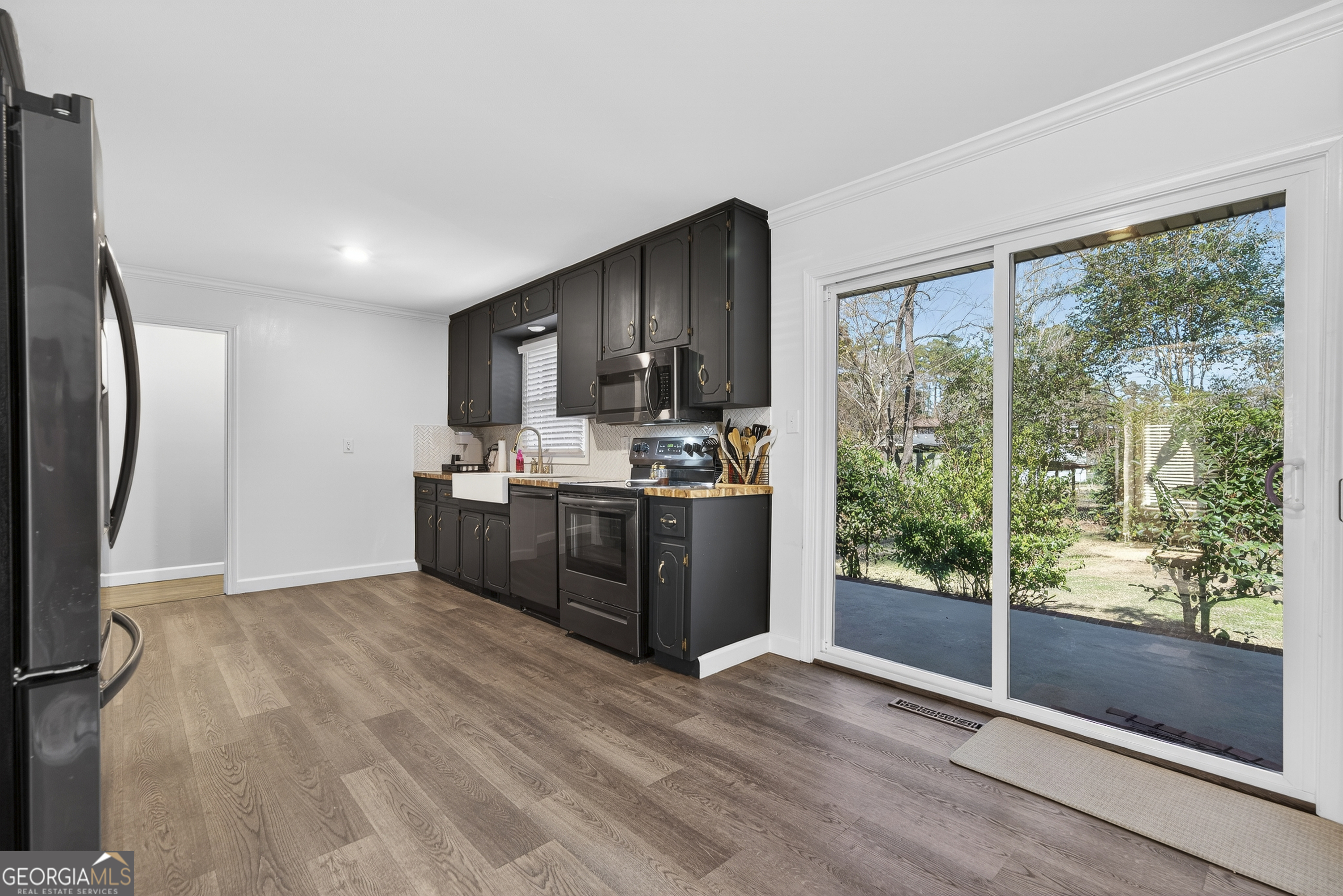 1739 Elmwood Road Milledgeville, GA 31061 - Photo 24 of 41 a kitchen with stainless steel appliances a refrigerator sink and cabinets