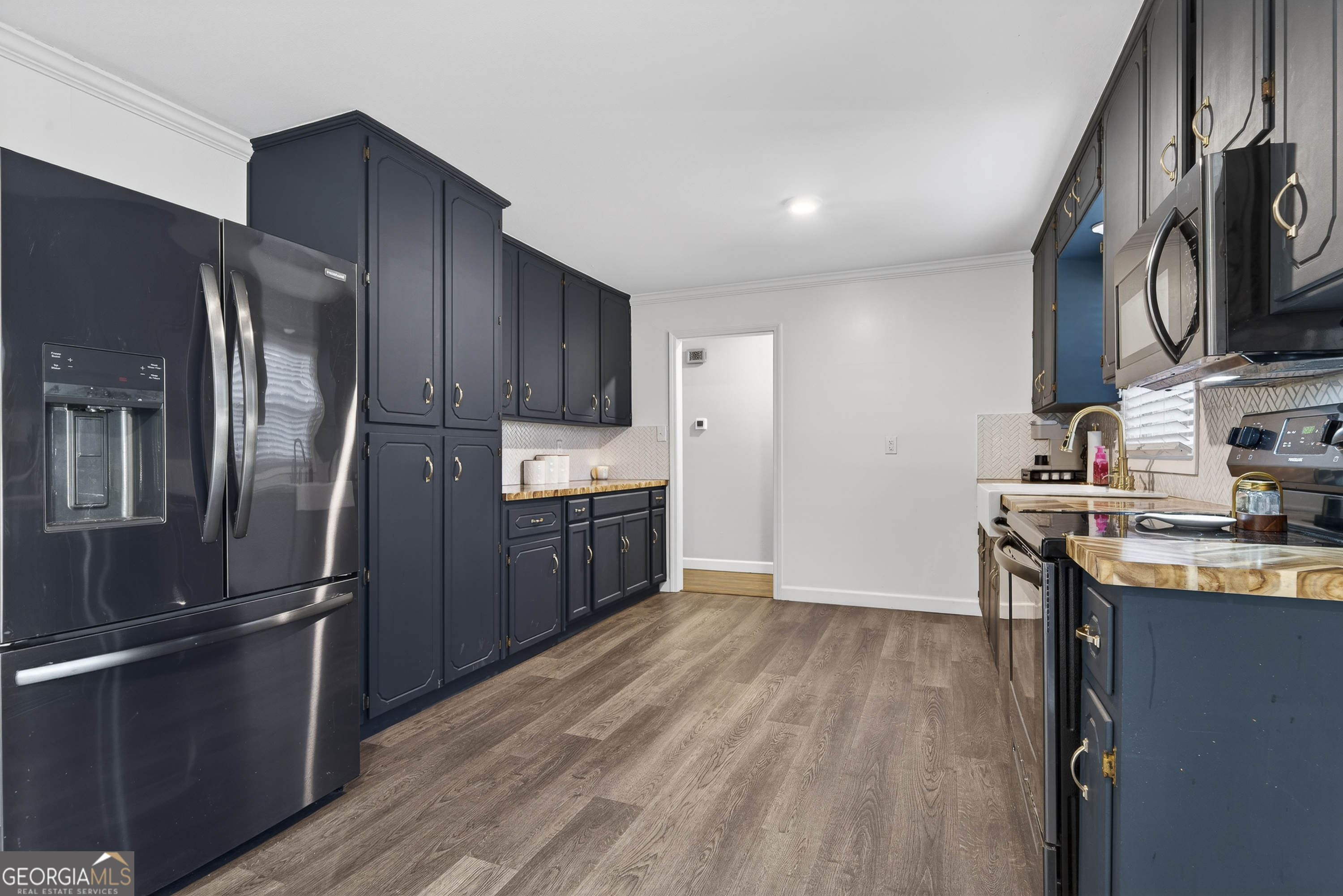 1739 Elmwood Road Milledgeville, GA 31061 - Photo 25 of 41 a kitchen with stainless steel appliances granite countertop a refrigerator microwave and sink