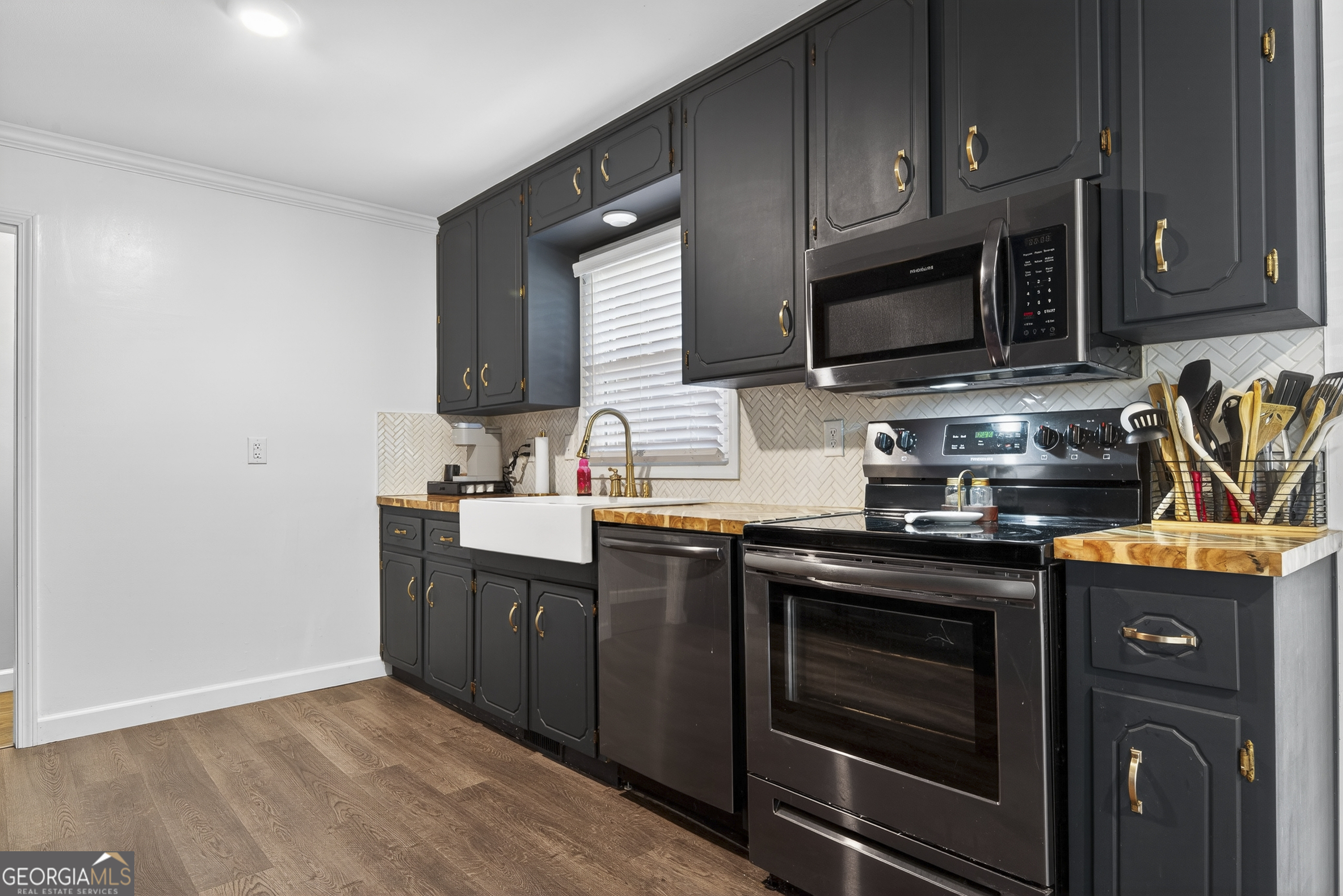 1739 Elmwood Road Milledgeville, GA 31061 - Photo 26 of 41 a kitchen with stainless steel appliances granite countertop a stove microwave and sink
