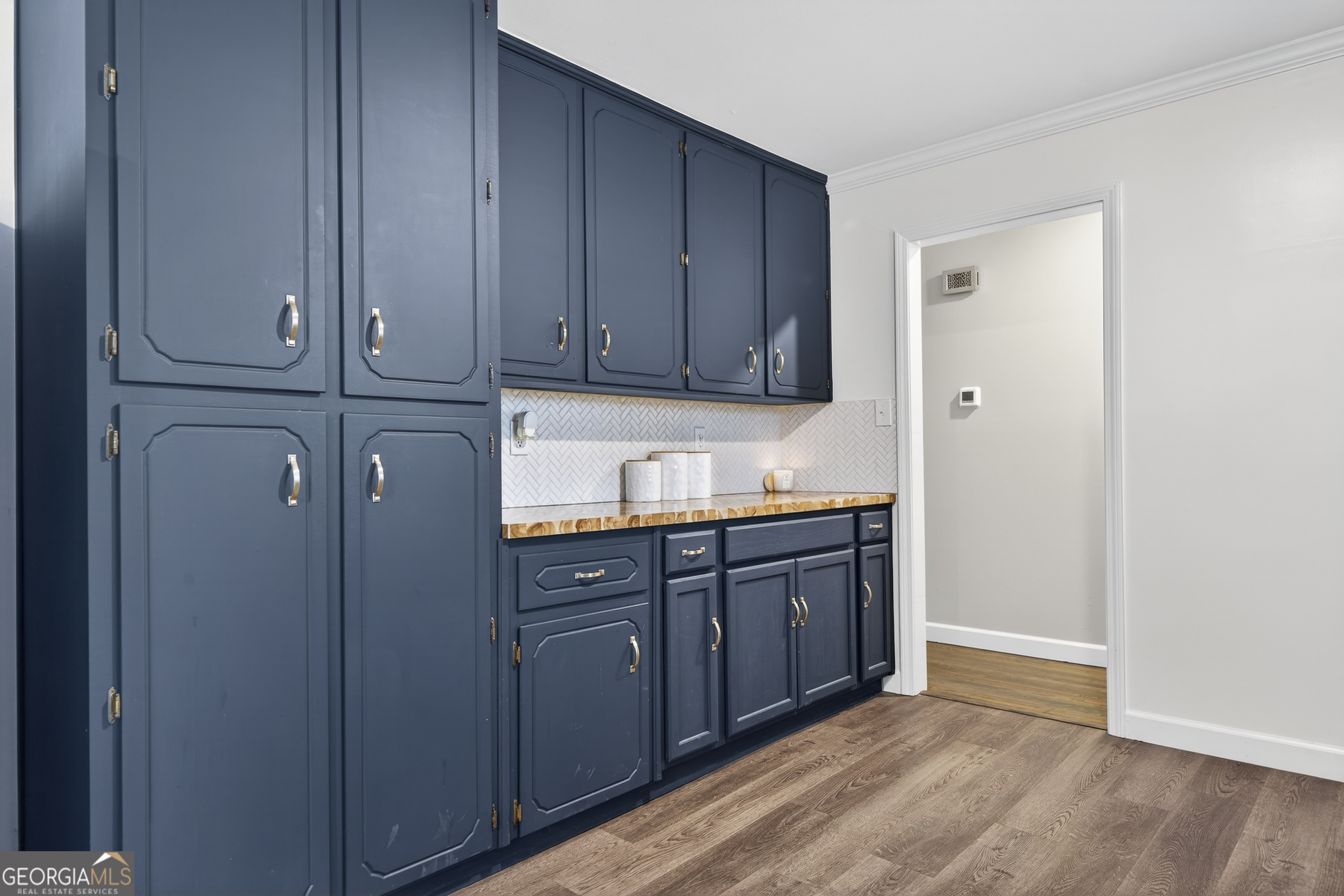1739 Elmwood Road Milledgeville, GA 31061 - Photo 27 of 41 a kitchen with granite countertop wooden cabinets and sink