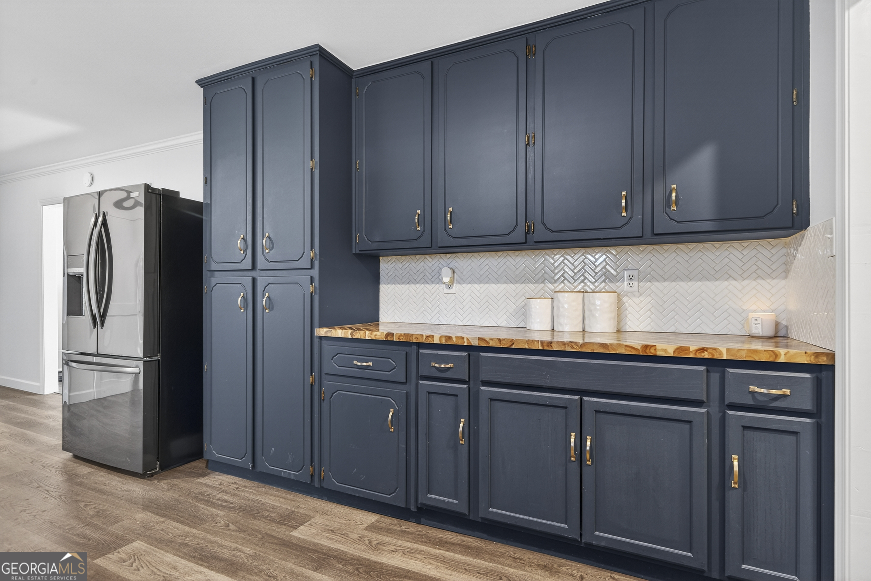 1739 Elmwood Road Milledgeville, GA 31061 - Photo 29 of 41 a kitchen with granite countertop wooden cabinets and refrigerator