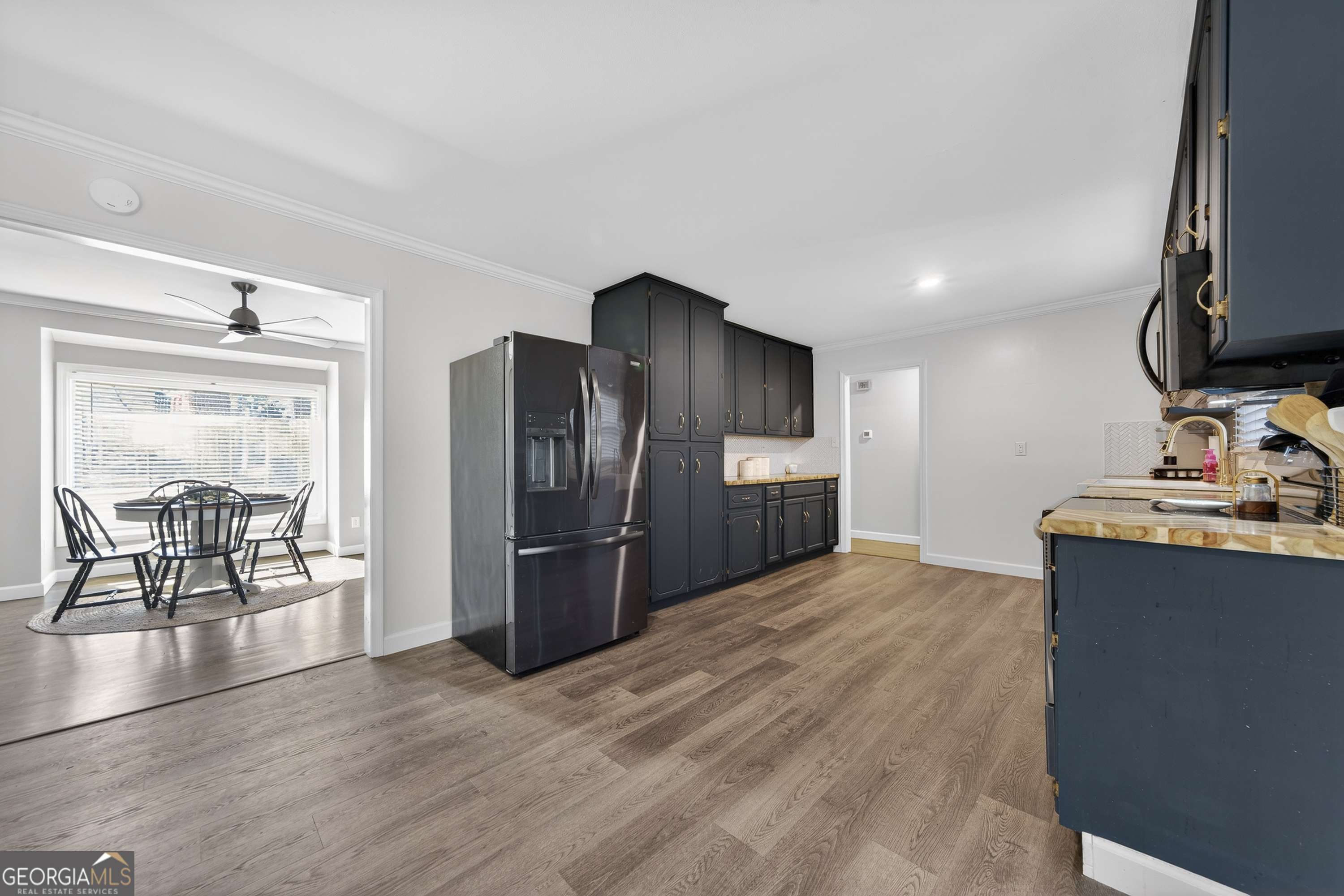 1739 Elmwood Road Milledgeville, GA 31061 - Photo 30 of 41 a kitchen with stainless steel appliances kitchen island granite countertop a refrigerator and a stove top oven