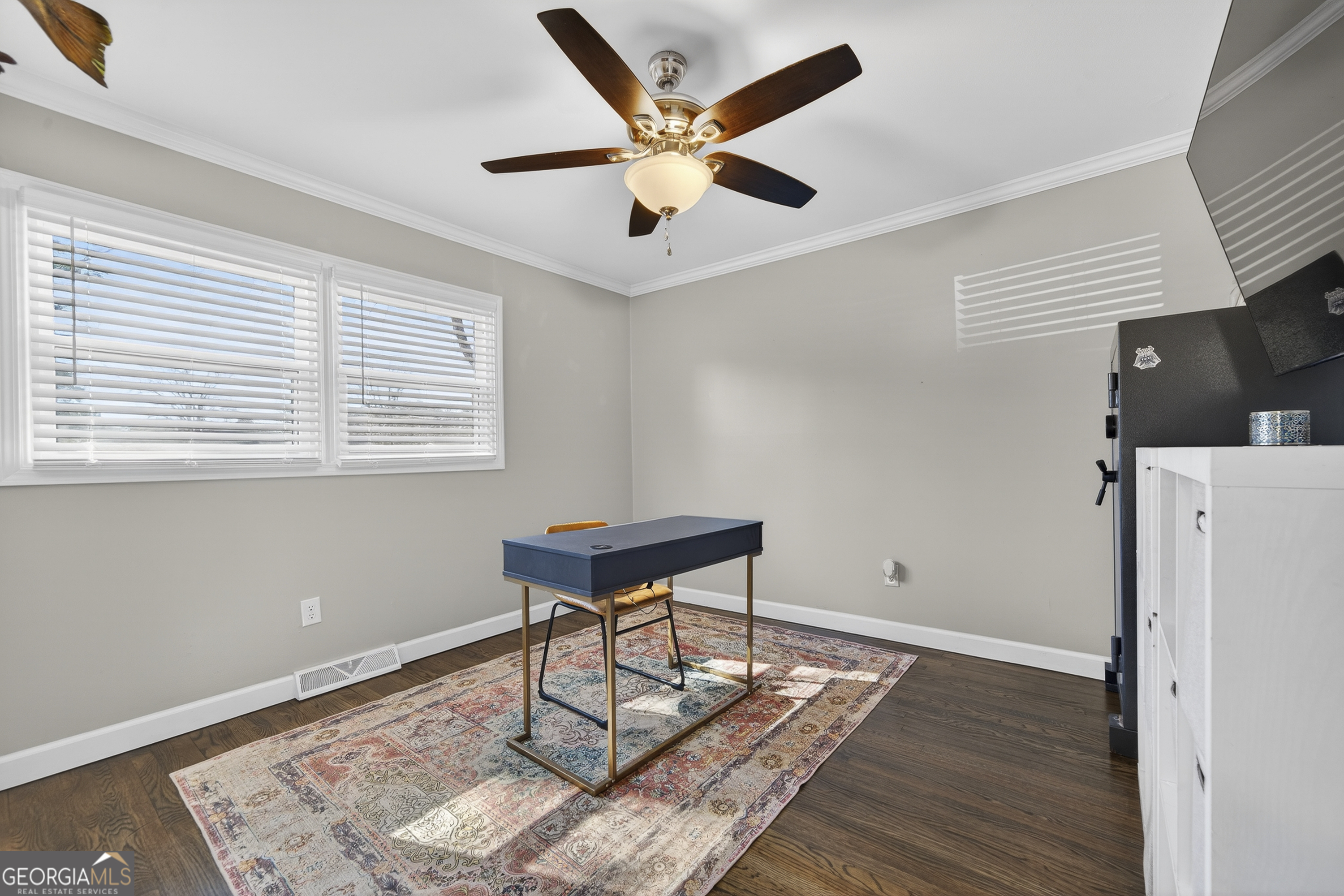 1739 Elmwood Road Milledgeville, GA 31061 - Photo 8 of 41 a work room with wooden floor and white walls