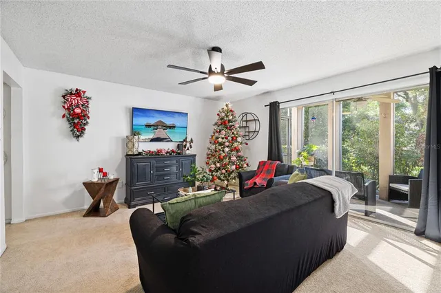 a living room with furniture a chandelier and a flat screen tv