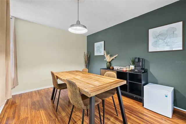 a view of a dining room with furniture and wooden floor