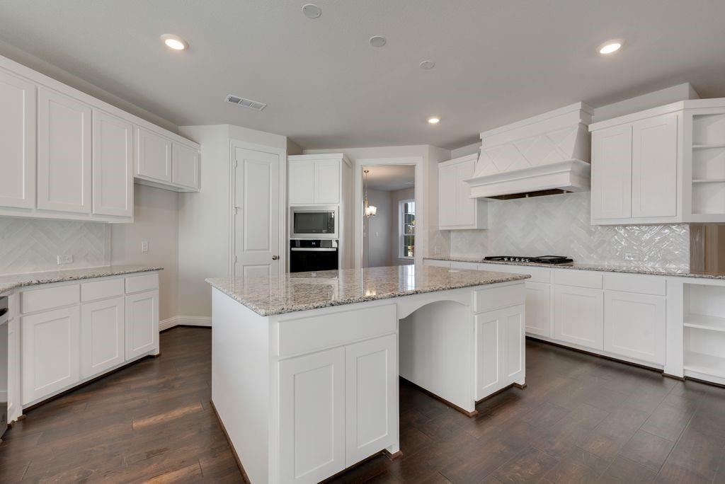 2438 Meridian Place Midlothian, TX 76065 - Photo 11 of 37 a kitchen with white cabinets appliances and sink