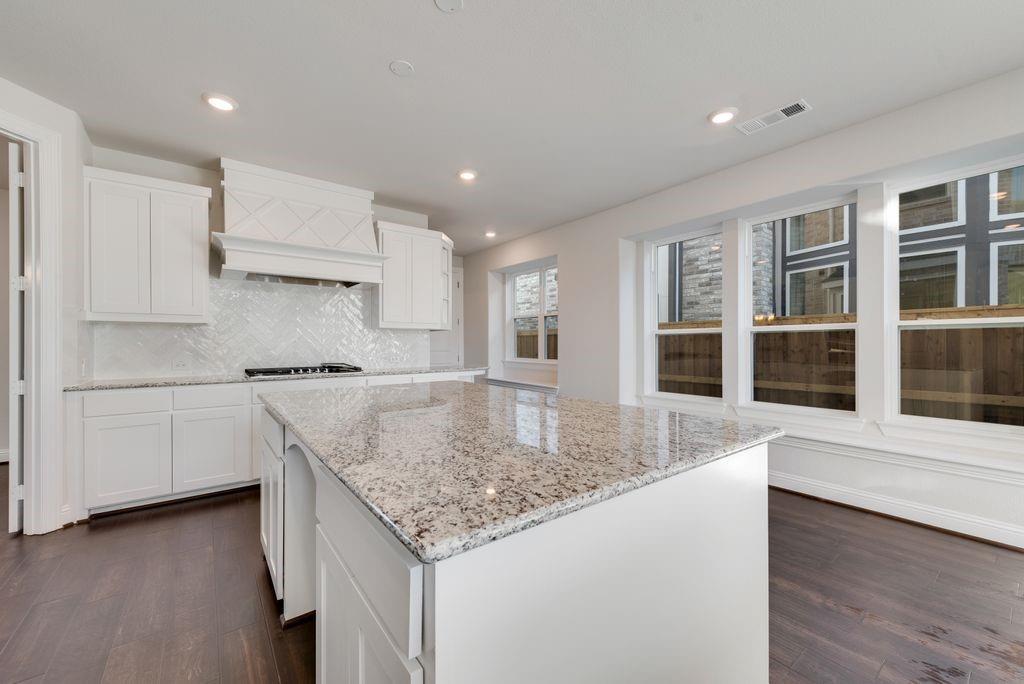 2438 Meridian Place Midlothian, TX 76065 - Photo 13 of 37 a kitchen with stainless steel appliances granite countertop a sink dishwasher and stove with wooden floor