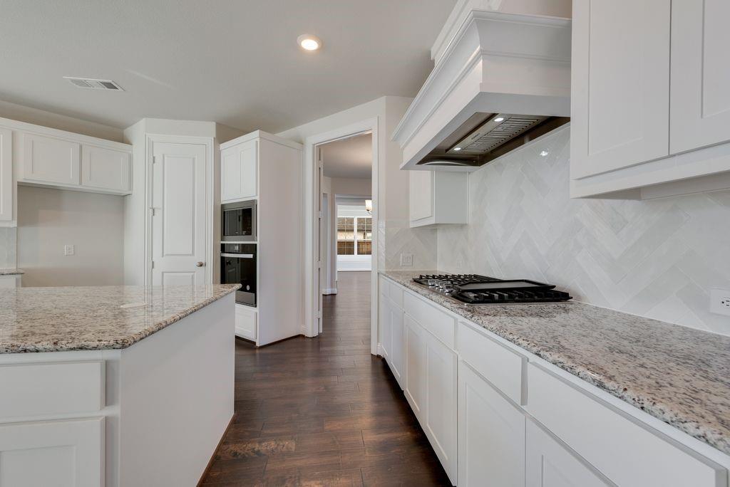 2438 Meridian Place Midlothian, TX 76065 - Photo 15 of 37 a kitchen with stainless steel appliances granite countertop a sink stove and refrigerator