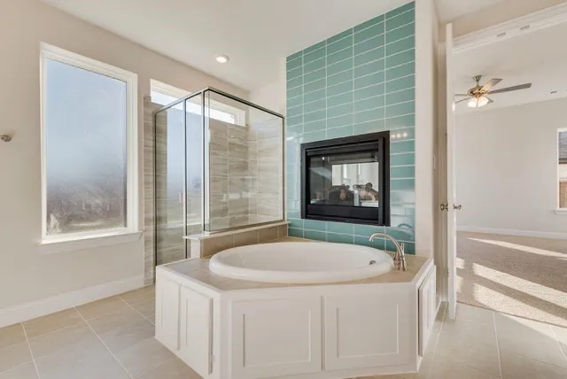a bathroom with a tub and a shower