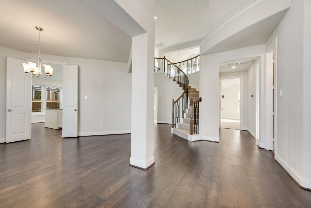 2438 Meridian Place Midlothian, TX 76065 - Photo 5 of 37 a view of a hallway with wooden floor and windows