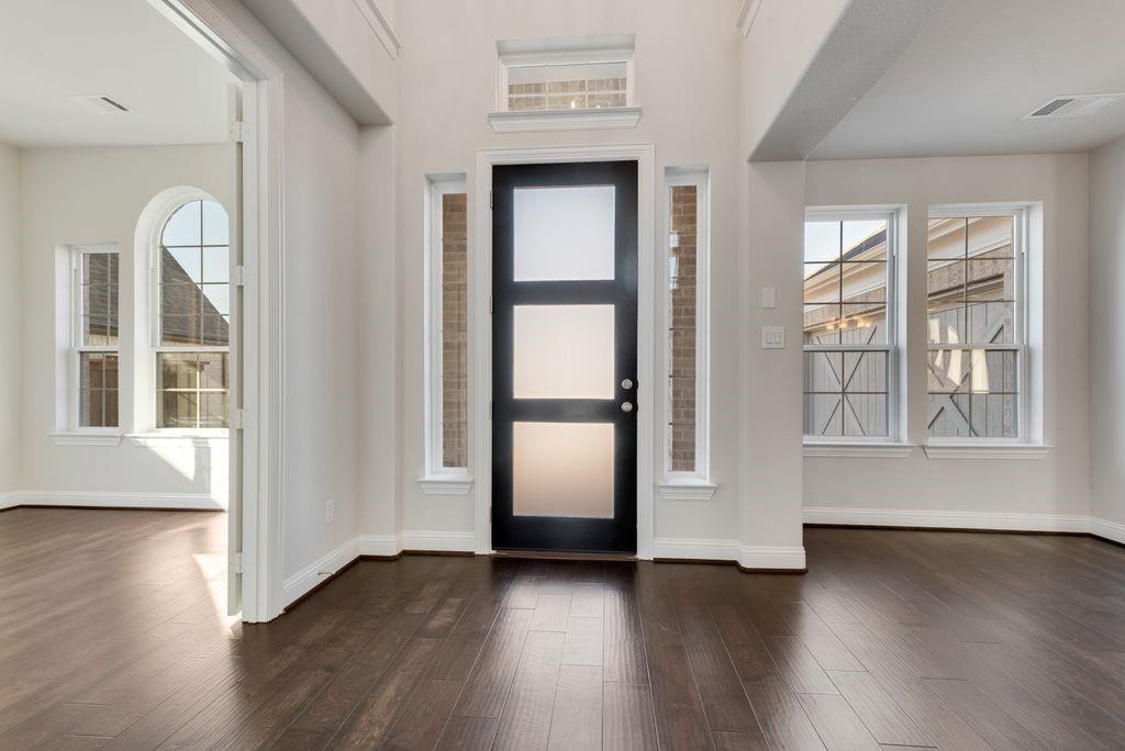 2438 Meridian Place Midlothian, TX 76065 - Photo 6 of 37 an empty room with wooden floor and windows