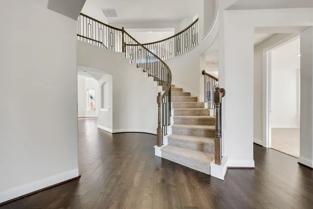 a view of entryway and hall with wooden floor