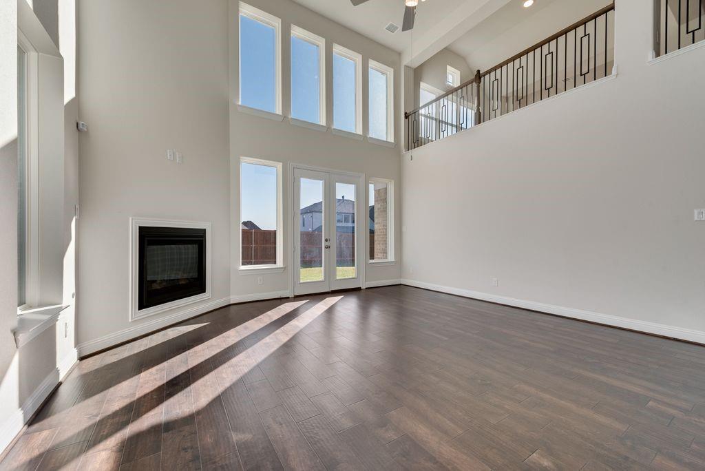 2438 Meridian Place Midlothian, TX 76065 - Photo 8 of 37 a view of an empty room with wooden floor and a window