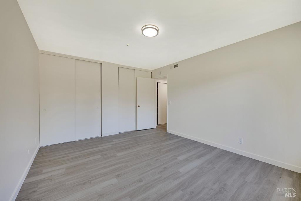 1155-1175 Evans Drive Santa Rosa, CA 95405 - Photo 27 of 31 a view of an empty room with wooden floor
