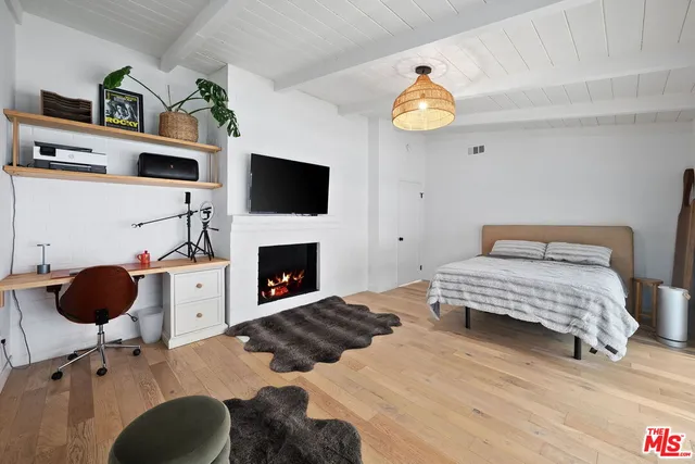 a bedroom with a bed and a fireplace