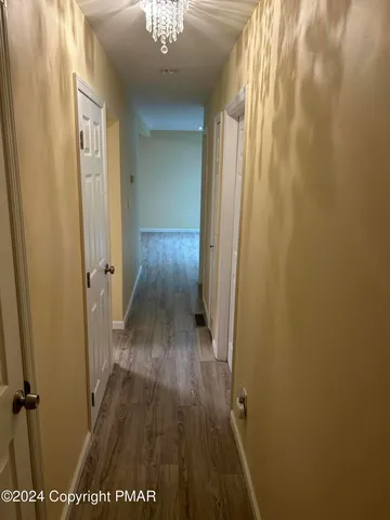 a view of a room with wooden floor