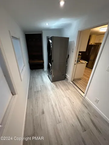 a view of a hallway with wooden floor